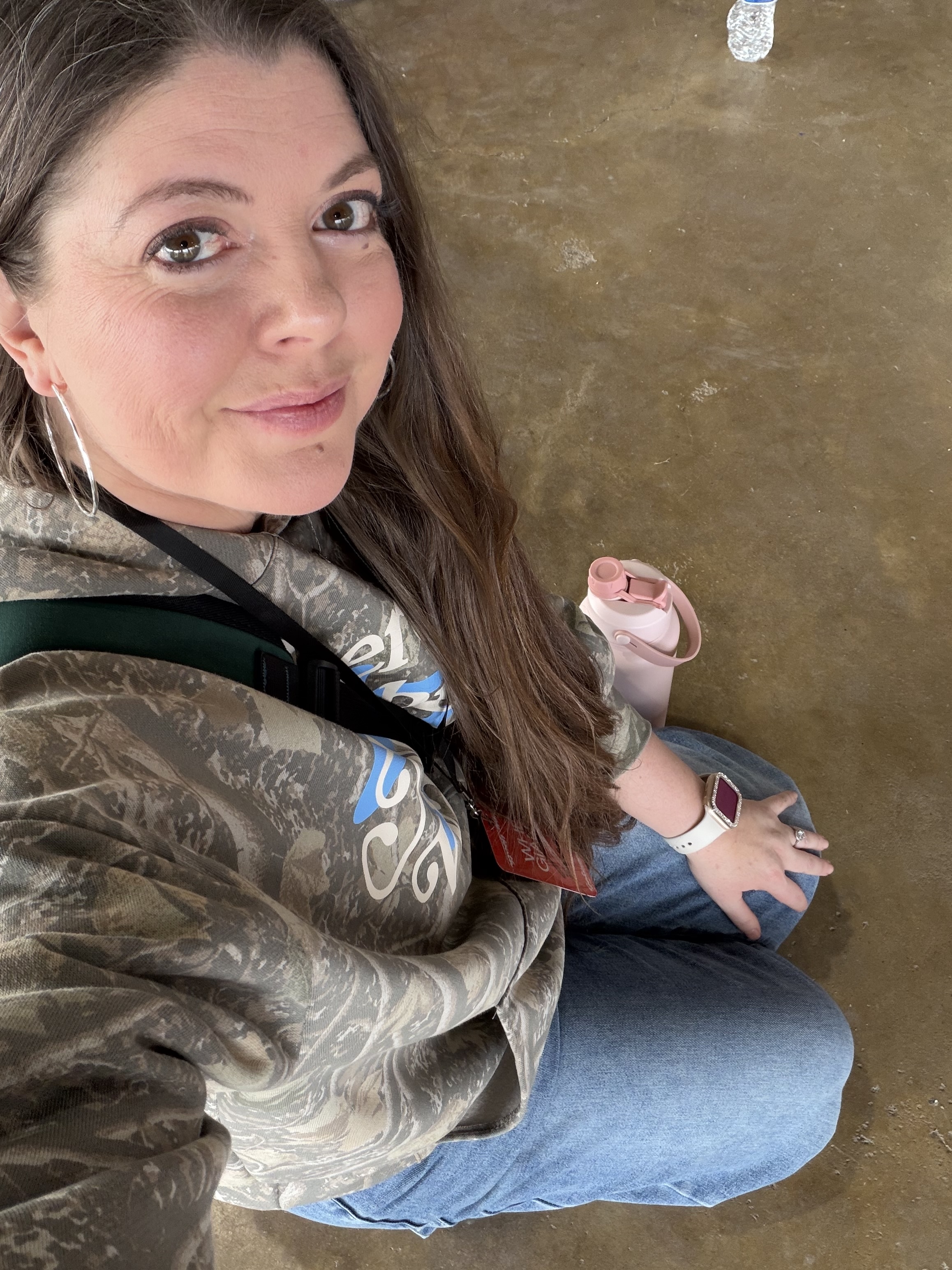 Melissa kneeling on the ground at youth camp in March, no knee pain for the first time in years